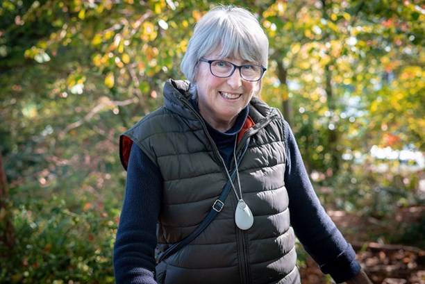 Woman wearing personal alarm pendant outdoors