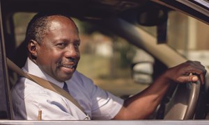 Smiling man driving car