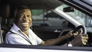 Smiling man driving car