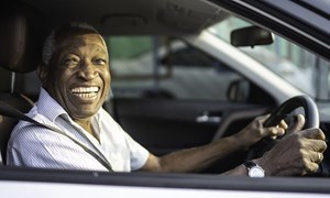 Smiling man driving car