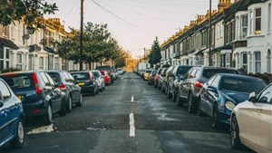 Parked cars either side of a residential street