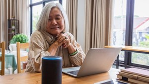 Woman sat down with an Alexa speaker on the table