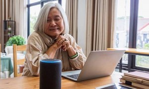 00038 - Woman sat down with an Alexa speaker on the table - 5.3