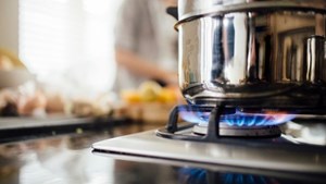 Saucepan on a lit gas kitchen stove