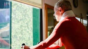 Man on bike machine in home gym.