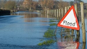 Flooded road with flood warning sign