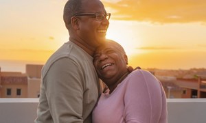 Couple embracing on a rooftop at sunset