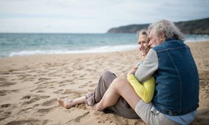 Couple cuddling on a beach